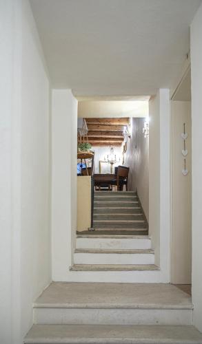 a hallway with stairs leading to a dining room at Alloggi I Calieroni in Valstagna
