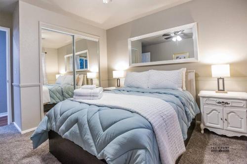a bedroom with a large bed and a mirror at Paso House in Redding