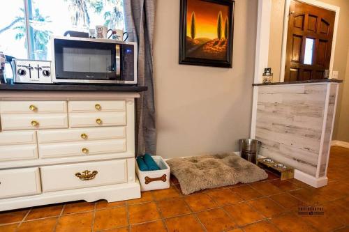 a room with a dresser with a microwave on top of it at Paso House in Redding