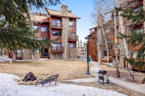 a house with a fire pit in front of it at Pine Ridge Condos in Breckenridge