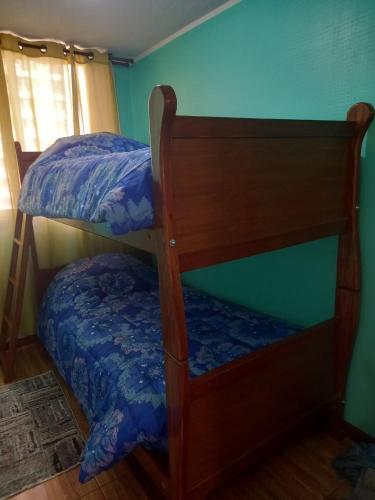 two bunk beds in a room with a blue wall at Departamento Santiago centro in Santiago