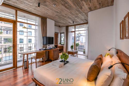 a bedroom with a bed and a desk with a television at 22Land Hotel & Residence in Hanoi