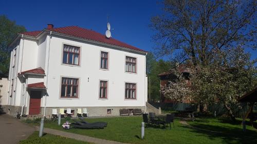 a large white building with a red roof at Villa Meri Apartments in Pärnu