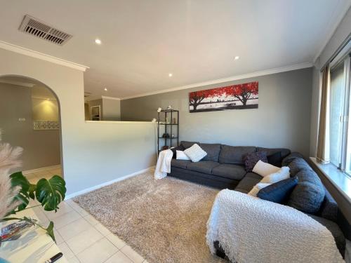 a living room with a couch and a rug at Blackwood Stays in Spearwood