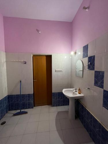 a bathroom with a sink and a shower at Travel curiosity Homestay in Alwar