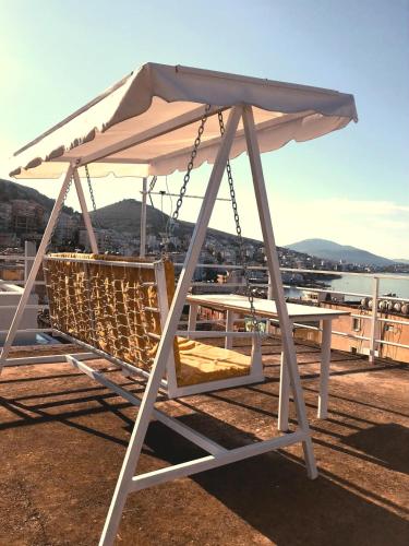 a white umbrella sitting on top of a table at Joen Apartments in Sarandë