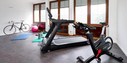 a gym with a treadmill and a bike in a room at Sonnenuhr in Bernkastel-Kues