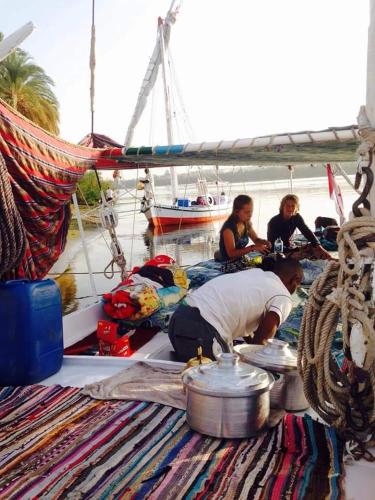 a group of people on a boat in the water at Habibi Nubian Guest House-Nubian Hospitality in Aswan