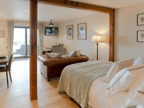 a bedroom with a bed and a chair and a desk at Cuillin Studio - Ukc6562 in Mallaig