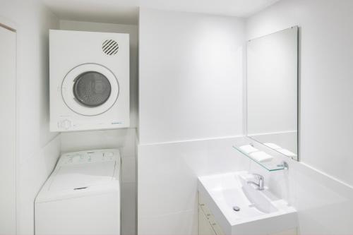 城堡山Mantra Castle Hill Sydney, an Accor Hotel的带洗衣机和水槽的白色浴室