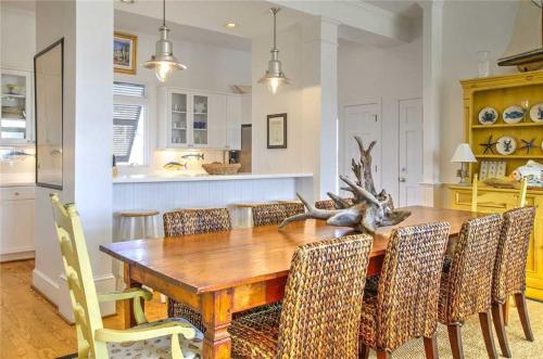 a dining room with a wooden table and chairs at Nash Cottage home in Atlantic Beach