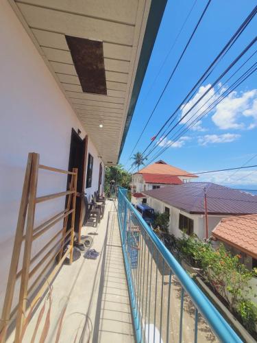 a balcony of a house with a blue railing at Gaja Go Dive & Inn in Moalboal