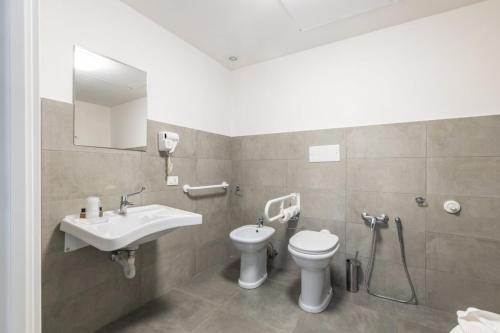 a bathroom with a sink and a toilet at L'Essenza Hotel in Olbia