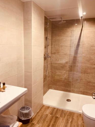 a bathroom with a shower with a toilet and a sink at Hôtel Esprit d'Azur in Nice