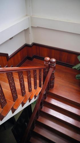 a set of stairs in a room with wooden floors at Villa KiengKham晶康民宿 in Luang Prabang