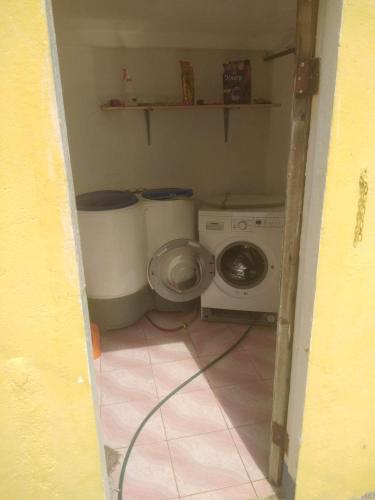a small bathroom with a washing machine and a washer at Hideaway Resort Victoria secret hideaway resort in Maraat