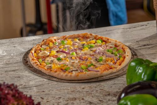 a pizza sitting on top of a table at Hotel Mona Lisa Wellness & Spa in Kołobrzeg