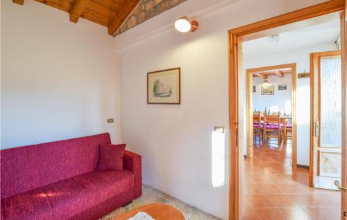 a living room with a red couch and a dining room at Awesome Home In Sovramonte With Wifi in Sovramonte