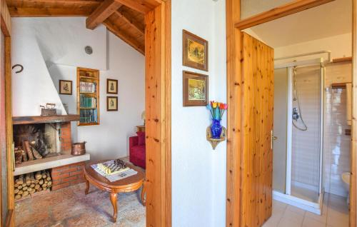 a living room with a fireplace and a table at Awesome Home In Sovramonte With Wifi in Sovramonte