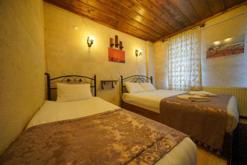 Goreme Cave Rooms&Poolにあるベッド
