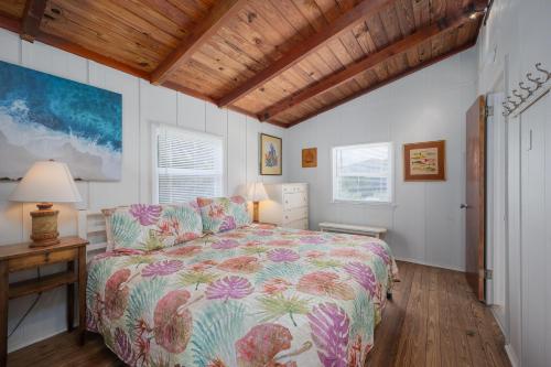 a bedroom with a bed and a wooden ceiling at Pounds Cottage, 1 Bedroom, Sleeps 4, Ocean Front, Pet Friendly in Butler Beach