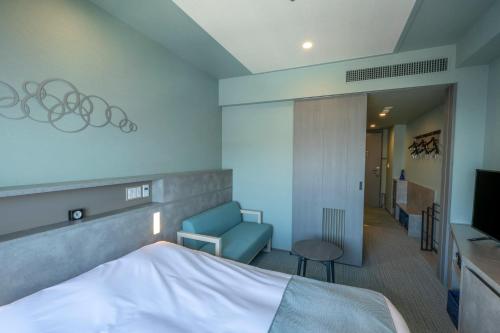 a hotel room with a bed and a chair and a television at La Vista Tokyo Bay in Tokyo