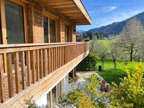 a balcony of a house with a view of a yard at CHALET KITZBICHL, your Holiday Hideaway by Belle Stay in Reith bei Kitzbühel