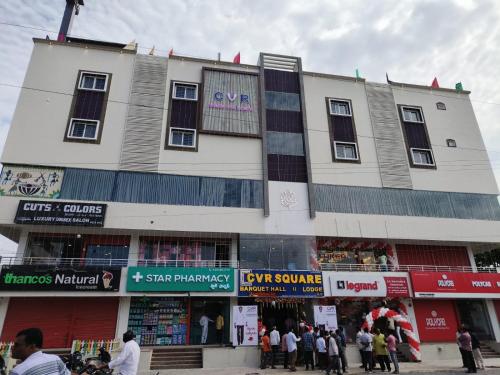 a large building with people standing outside of it at CVR Banquet Hall And Lodging in Khammam