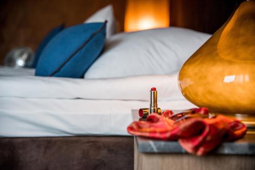 a hotel room with a bed and a table with a lamp at Billingehus in Skövde