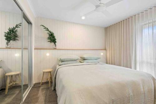 a bedroom with a bed and two stools in it at Terra Mare in Geelong West