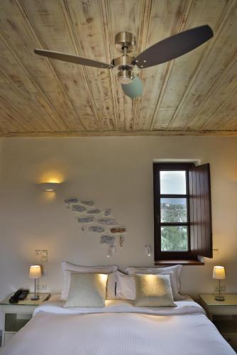 a bedroom with a large bed with a ceiling at Castello Antico Hotel in Gythio
