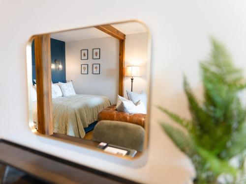 a reflection of a bedroom in a mirror at Skye Studio - Ukc6566 in Mallaig