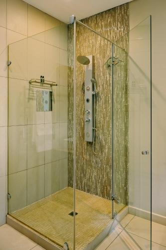 a shower stall with a glass door in a bathroom at Tredenham Boutique Hotel in Bloemfontein