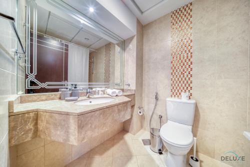 a bathroom with a toilet and a sink at Elegant Studio at Al Madar Siraj Tower 1 Al Barsha South by Deluxe Holiday Homes in Dubai