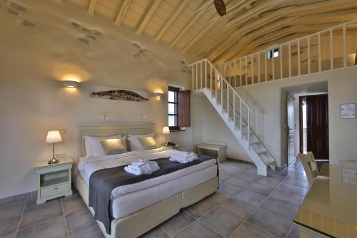 a bedroom with a bed in a room with a staircase at Castello Antico Hotel in Gythio