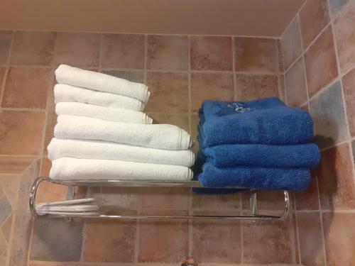 a stack of towels on a towel rack in a bathroom at Castello Antico Hotel in Gythio