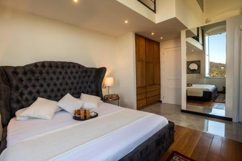 a bedroom with a large bed with a large window at Torre Scribanti in Sestri Levante