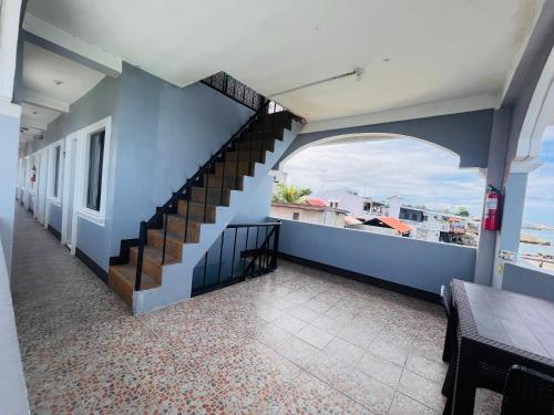 a balcony with a staircase in a house at Danao LC Bayview in Idanao