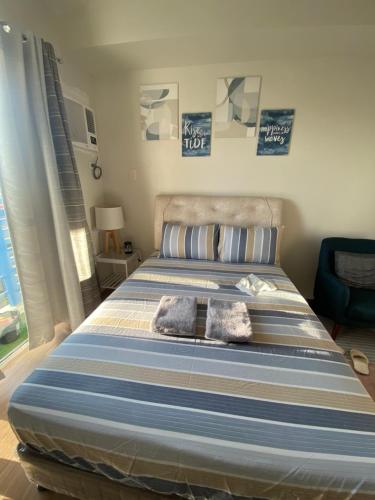 a bedroom with a bed with two towels on it at Studio unit at The Loop in Cagayan de Oro