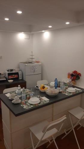 una encimera de cocina con platos y tazones de comida. en B&B Italian Guest Genova, en Génova