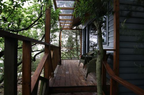 a wooden walkway leading up to a house at Chingjing Abin Minshuku in Renai