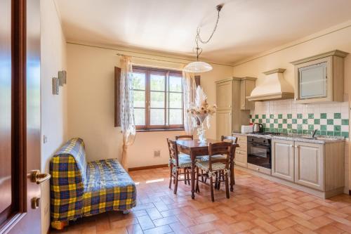a kitchen with a dining room table and chairs at Casolare dei Fiori - Mughetto in Montecarlo