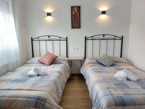 Postel nebo postele na pokoji v ubytování Apartamentos El Pozo