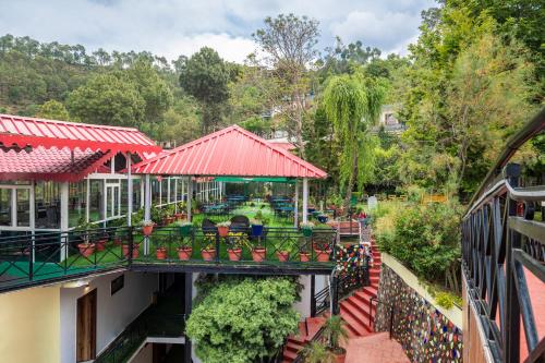 a view from a balcony of a building with a garden at Maple Resort Chail in Shimla