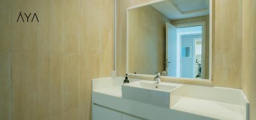a bathroom with a white sink and a mirror at AYA Boutique - Beach View in this 1BR Apartment in Dubai Marina in Dubai