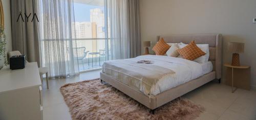 a bedroom with a bed and a large window at AYA Boutique - Beach View in this 1BR Apartment in Dubai Marina in Dubai
