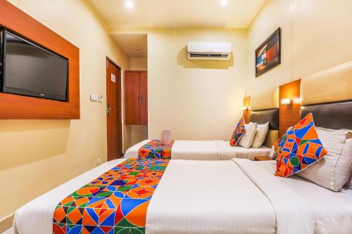 Postel nebo postele na pokoji v ubytování FabHotel Liwa International - Nr Mumbai International Airport