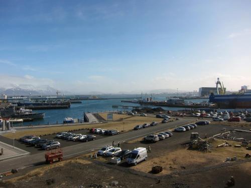 a parking lot with cars parked next to the water at Reykjavík Central Apartments in Reykjavík