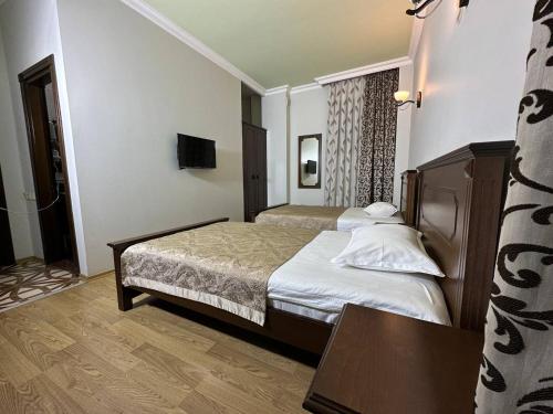 a hotel room with a bed and a table at Eiffel Hotel in Batumi