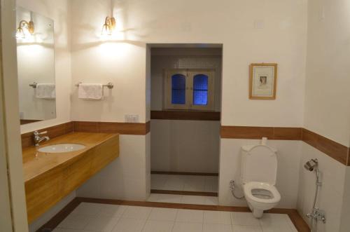a bathroom with a toilet and a sink at Bhairon villas in Bikaner